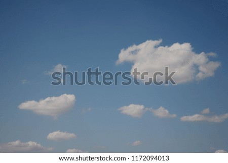 The usual colors of blue sky and white light clouds show the simplicity of nature