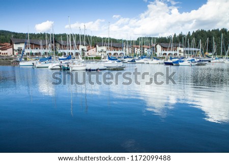 Beautiful view of Sailing boats reflecting on surface of water. Nice modern harbor in background. Lipno nad Vltavou, Czech Republic. Amazing sunny day, blue sky with clouds. Perfect HD wallpaper 4k