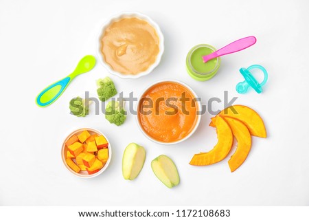 Flat lay composition with bowls of healthy baby food on white background Royalty-Free Stock Photo #1172108683