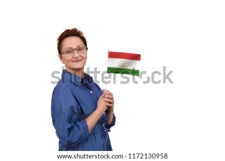 Tajikistan flag. Woman holding Tajikistan flag. Nice portrait of middle aged lady 40 50 years old with a national flag isolated on white background.
