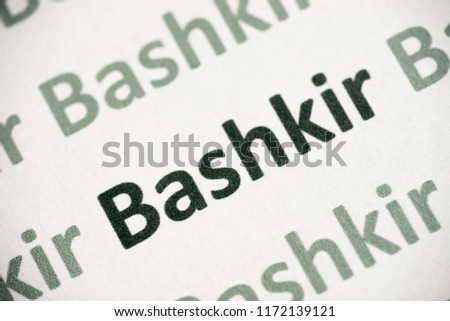 word Bashkir language printed on white paper macro