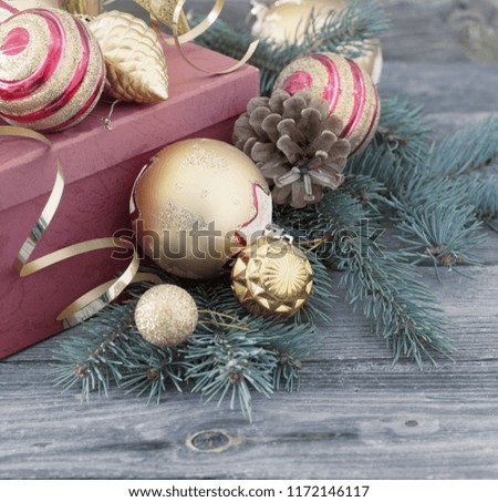 Christmas toys and red box on old wooden background