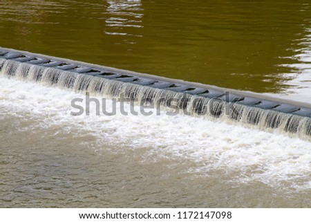 Water flowing over a river weir
