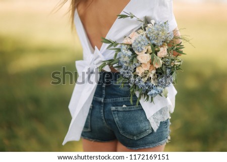 Beautiful mother have flower bouquet and have a good time near the nature