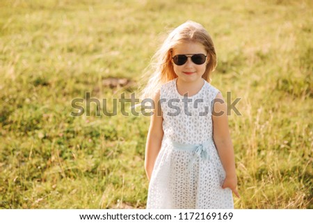 Little girl wears sunglasses and have fun