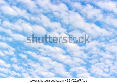 White fluffy cumulus clouds blue sky background texture