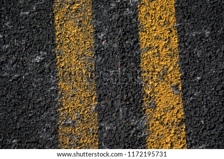 Double Yellow Line On Old Asphalt Road texture and background