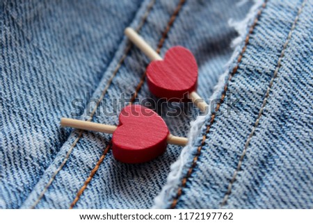 Denim. Jeans background. Denim jeans texture or denim jeans background. Red heart. Hearts. Red hearts in jeans pocket. Symbols of Valentine's Day, the day of all lovers