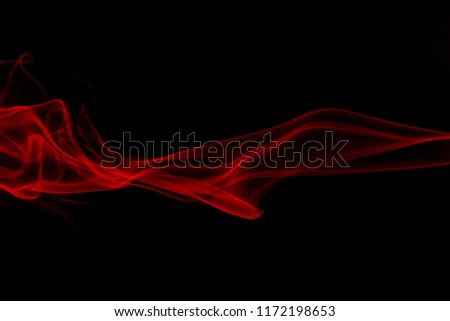 Smoke the red incense on a black background. darkness concept Royalty-Free Stock Photo #1172198653