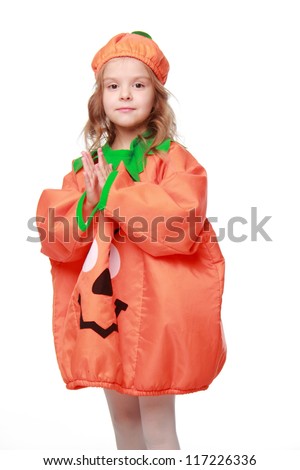 Studio image of little girl in pumpkin costume over light background