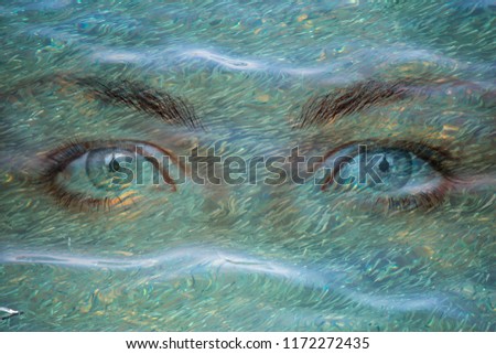 Girl eye look under wavy sea water