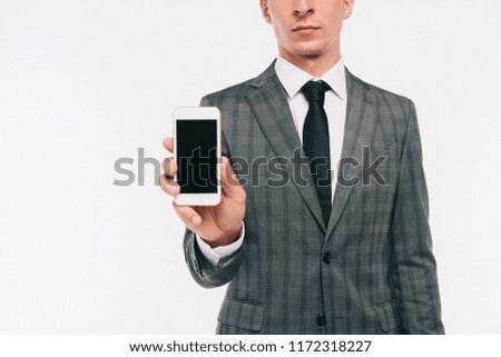 cropped image of businessman showing smartphone isolated on white