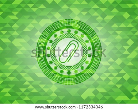 paper clip icon inside green emblem with triangle mosaic background