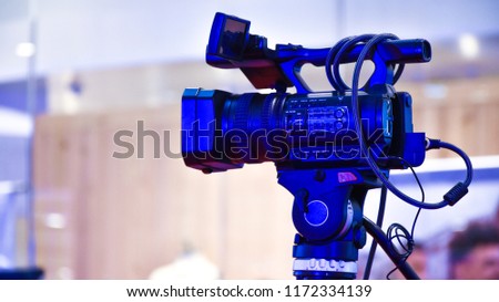 Full body of Video camera or Videographer in the event on background view. 
