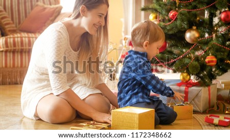 Happy family open gifts and presents for Christmas at morning
