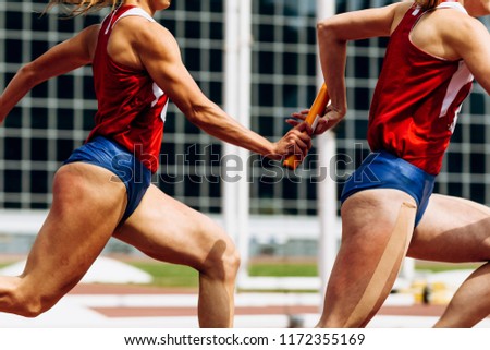 relay race passing of baton women team runners Royalty-Free Stock Photo #1172355169