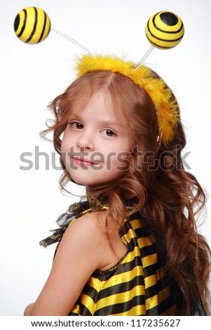 Portrait of  funny little girl as a yellow and black bee/Studio image of cute funny little girl as a bee