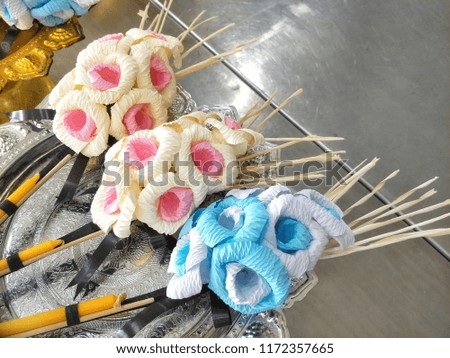 Colorful sandalwood flowers with incenses and candle on silver tray and stainless table for cremation ceremony, high angle view with copy space 