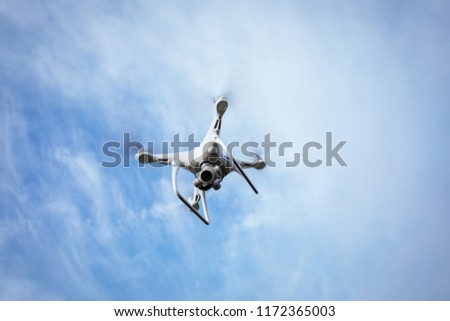 white drone flying in the air