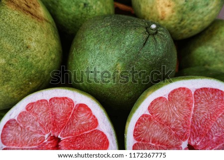 Pomelo is the largest of the citrus fruits, with a thick green skin and bitter pulp with sweet white or pink or red flesh.