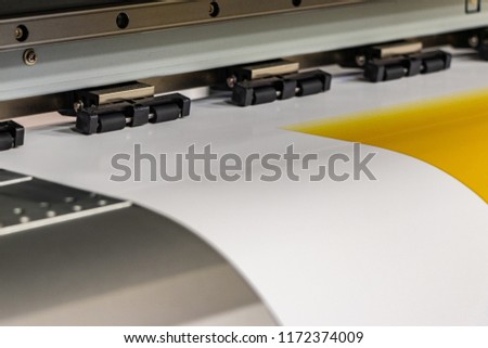 High quality, professional mega printer processing a deep yellow color sample. Moving blurred print head passing by.