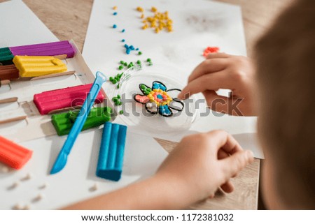 child play with plasticine. Colorful crafts. The concept of a happy childhood