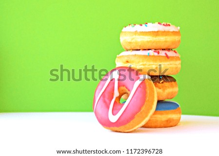 A few stacked donuts on a white background with a monochrome background