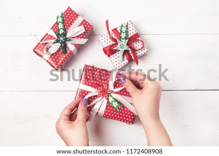 Christmas Background with Beautiful Gift Boxes Set of Christmas Gift Boxes New Year Background Female Hand Flat Lay