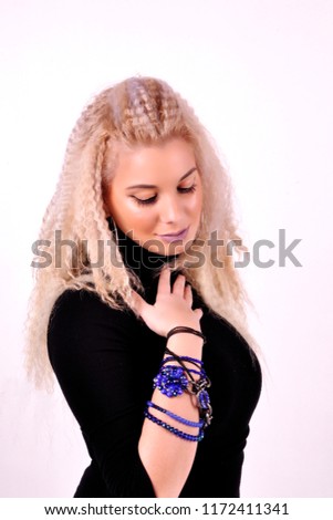blonde girl with an extravagant blue bracelet on her arm