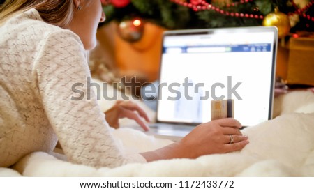 Closeup photo of young woman browsing online store for Christmas gifts