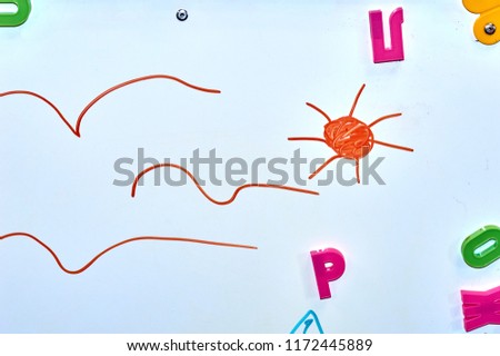 children's sun picture on a white marker board