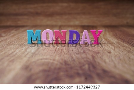 colorful monday alphabet letters on wooden background