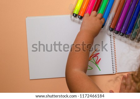 Adorable little girl drawing artwork top view