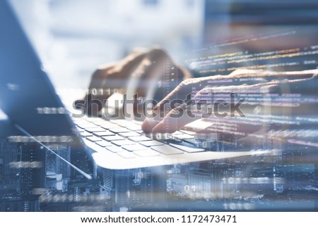 Business and modern technology, double exposure, man programmer coding on laptop computer and smart city with html code, binary on virtual screen, digital software technology development, IoT concept