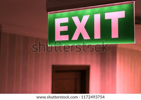 green ceiling hanging Exit Sign Shows People Way Out Public Building