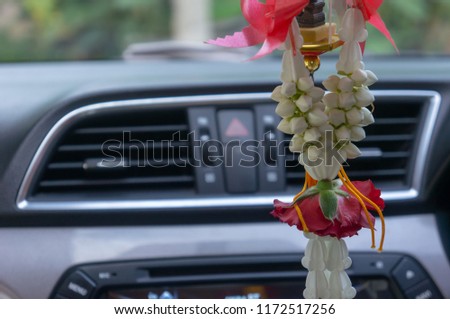 Rose and jasmine are decorated in the car to worship sacred Thai beliefs.