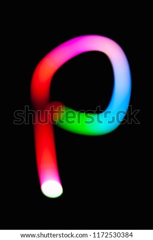 Letter P. Glowing letters on dark background. Abstract light painting at night. Creative artistic colorful bokeh. New Year. Use it for build you own design for book cover, CD, poster or post card.