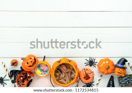 Table top view aerial image of decoration Happy Halloween day background concept.Flat lay accessories essential object to party the pumpkin & sweet candy on white wooden.Space for creative design. Royalty-Free Stock Photo #1172534815