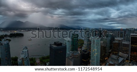 Aerial panoramic view of Downtown City during a stormy summer sunset. Taken in Vancouver, British Columbia, Canada.