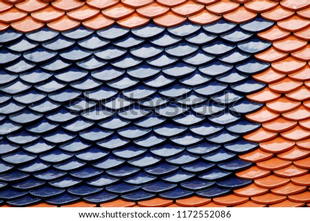 Abstract scene of Brown and Blue earthenware tiles or calls tiles consists of fish scales on the roof of temple bangkok thailand