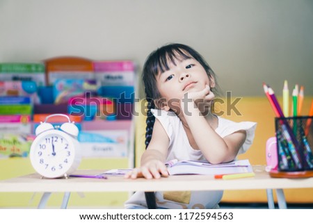 little student asian girl boring study lie down on a table. suffering from headache while doing overwork with learning , homework , study . school children education habit and parent concern concept. Royalty-Free Stock Photo #1172594563