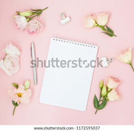 
Feminine home office workspace. Notebook with copyspace. Flat lay, magazines, social media, top view. Beauty business blog concept. Pink flowers and tea on pastel pink background. Wedding to do list.