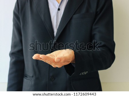 Close up of business mans hand showing something