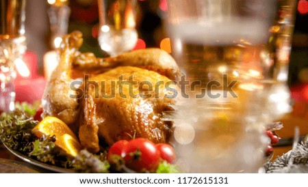 Closeup photo of frshly baked chicken and champagne in glass on family festive dinner
