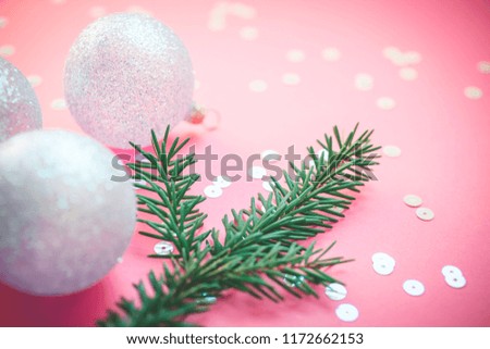 New Year Christmas Xmas holiday celebration composition pearl decorative toy balls green fir branch sparkles confetti pink paper background copy space Template frame for greeting postcard text design