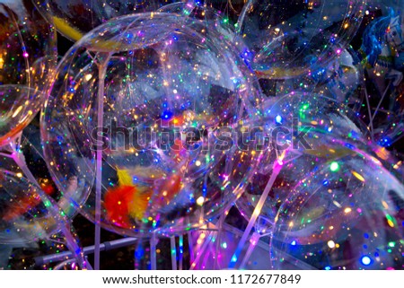 Colorful background of glowing balloons. Festival of LED decorations. The concept of energy-saving and cold lighting. Selective focus.