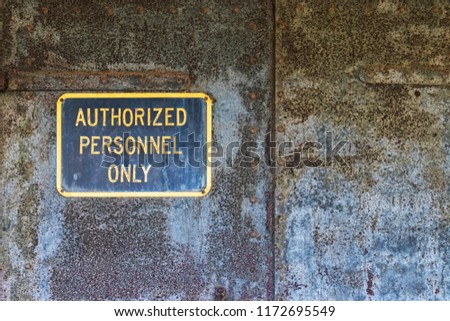 Authorized Personnel Only Sign on Rusty Peeling Metal Iron Door