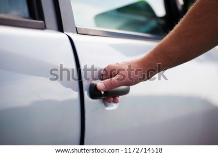 Open the car door. The man opens the car. Pull the door to you Royalty-Free Stock Photo #1172714518