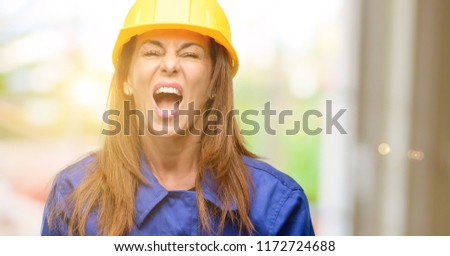 Engineer construction worker woman stressful, terrified in panic, shouting exasperated and frustrated. Unpleasant gesture. Annoying work drives me crazy