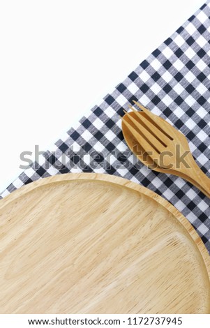Set of plate with  fork and spoon make from wooden on black and white fabric texture as background
